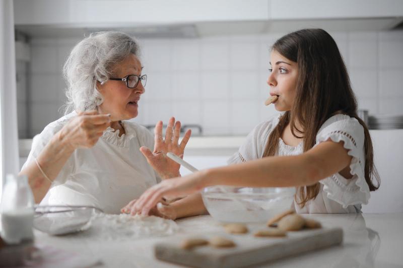 grandma and grandaughter bake cookies and chat