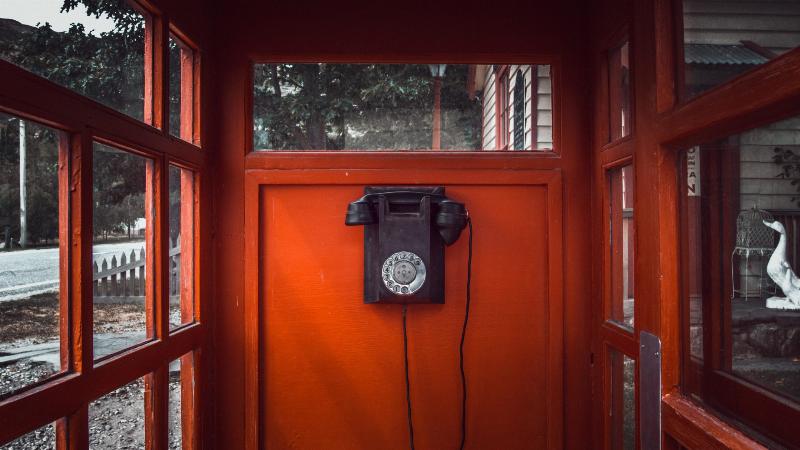 payphone hung up in red booth