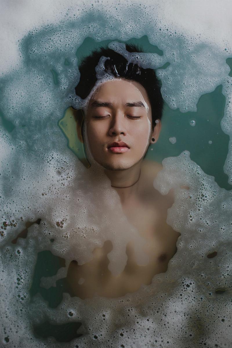 man laying bath water