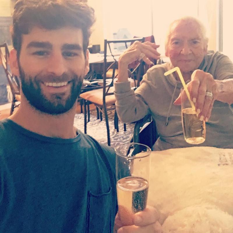 Chris and norma share a drink and take a selfie at restaurant