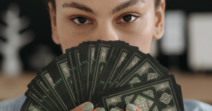 woman holding tarot cards