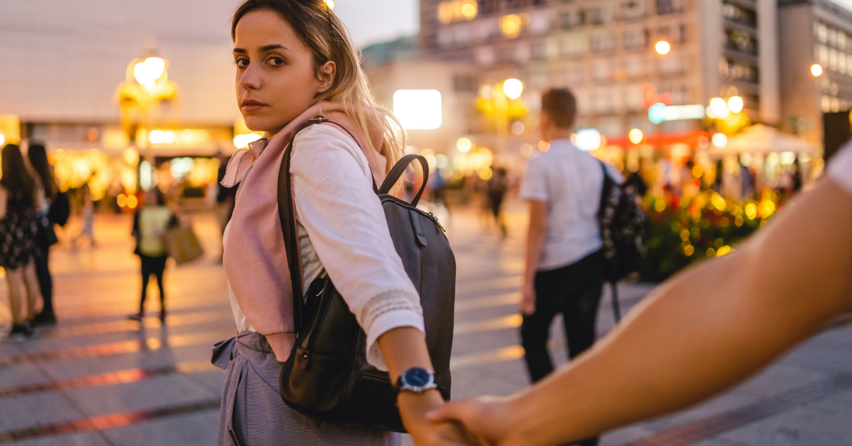 woman lading man by hand