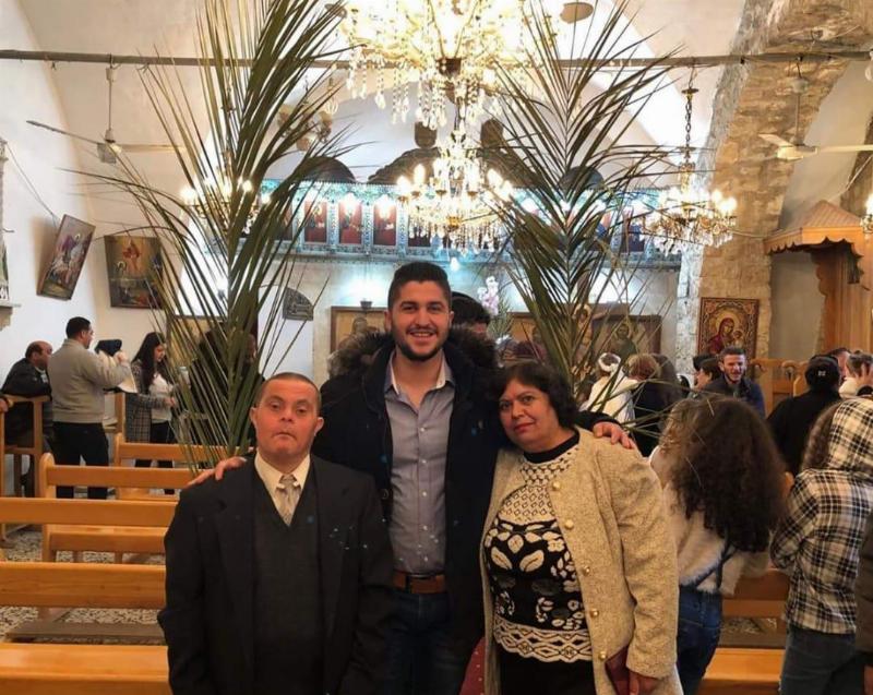 Sader poses with his parents at church
