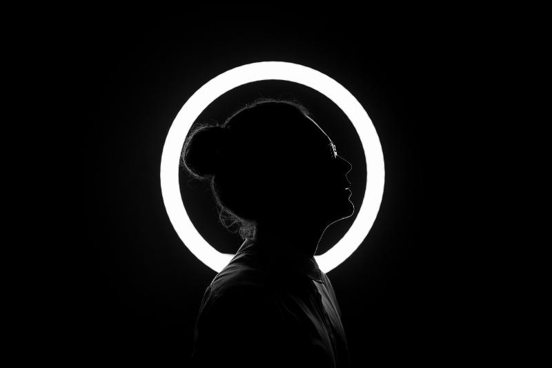 woman stands in front of halo