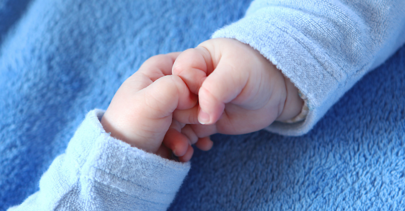 babies holding hands