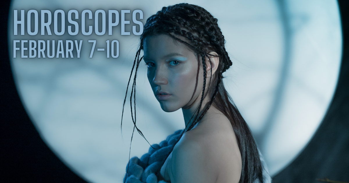 woman standing in moonlight with blue eyeshadow and rope dress