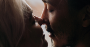 man and woman's face gets closer for a kiss