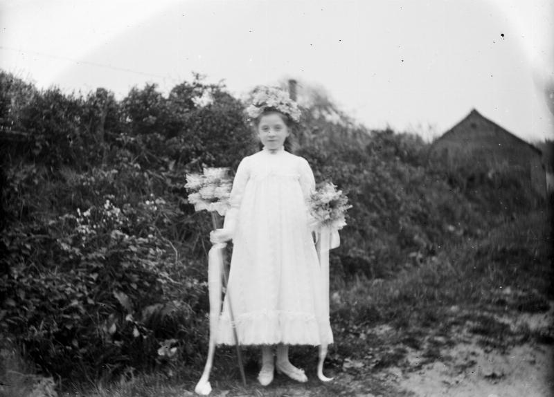 black and white photo of young girl holding flowers