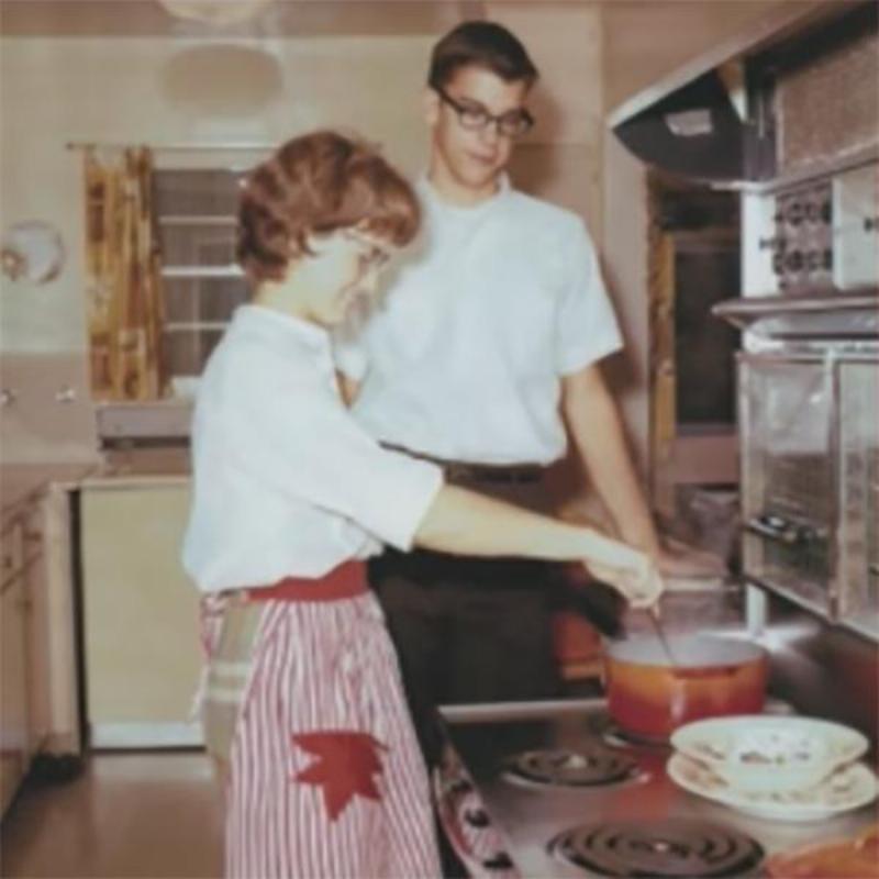 Prentiss and Janice cooking in the kitchen while young