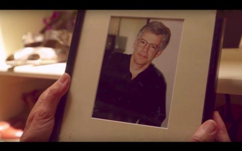 hands holding framed picture of Prentiss as an older man