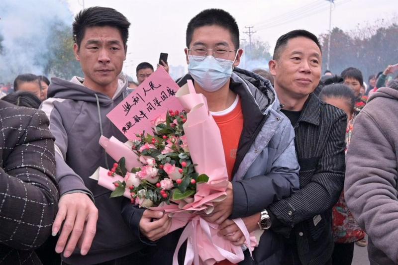 Sun Haiyang (R) welcomes his long-lost son Sun Zhuo (C) back to his hometown at Jianli on December 7, 2021 in Jingzhou, Hubei Province of China. After searching for 14 years, Sun Haiyang and his wife Peng Siying were reunited with their lost son Sun Zhuo on Monday in Shenzhen, Guangdong Province. Sun Zhuo was abducted at the age of 4 in 2007 in Shenzhen, and was found by police in 2021 in Shandong Province. Chinese 2014 movie 'Dearest', directed by Peter Chan Ho-sun, was based on the case of Sun Zhuo.