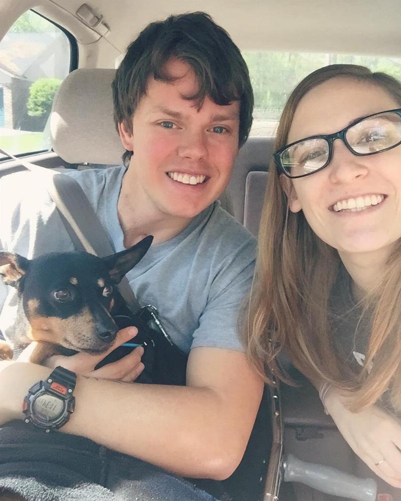 Matt, and Danielle pose for selfie with their dog in the car