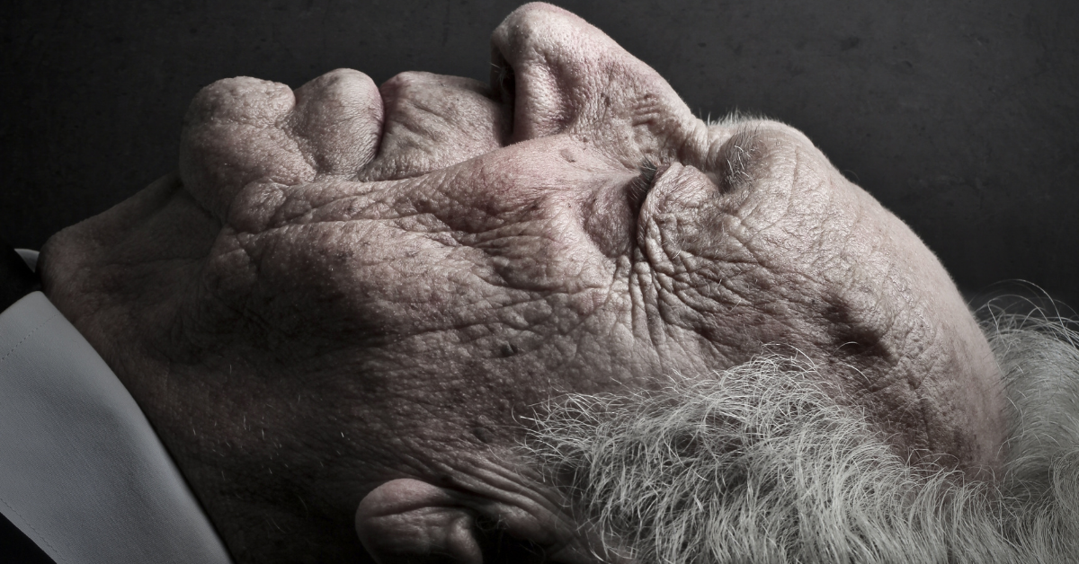 old man laying down with eyes close