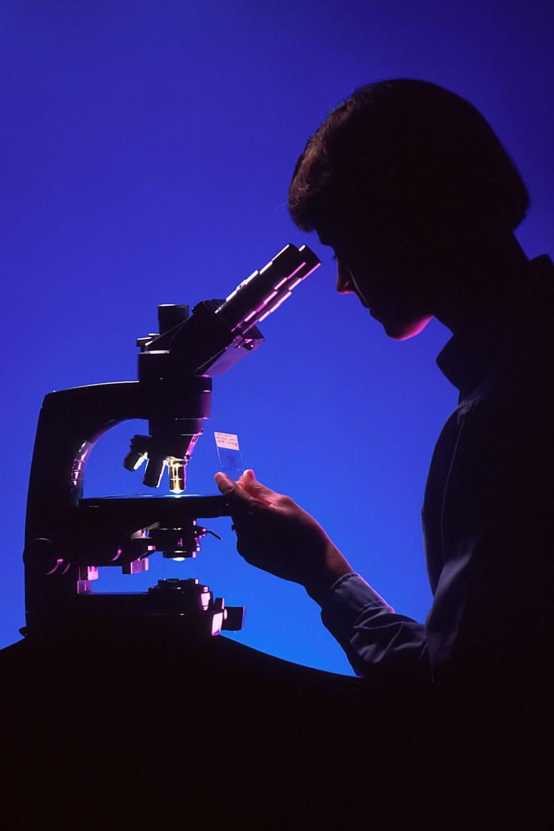 lab woman looking at binocular test sample