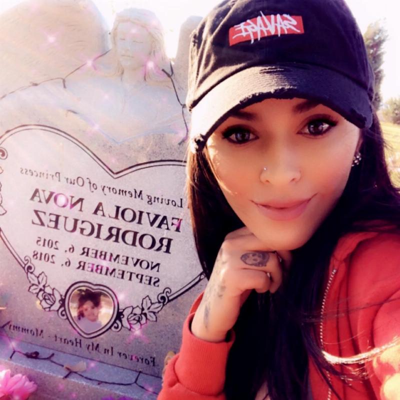 mom takes a selfie with her daughter's grave