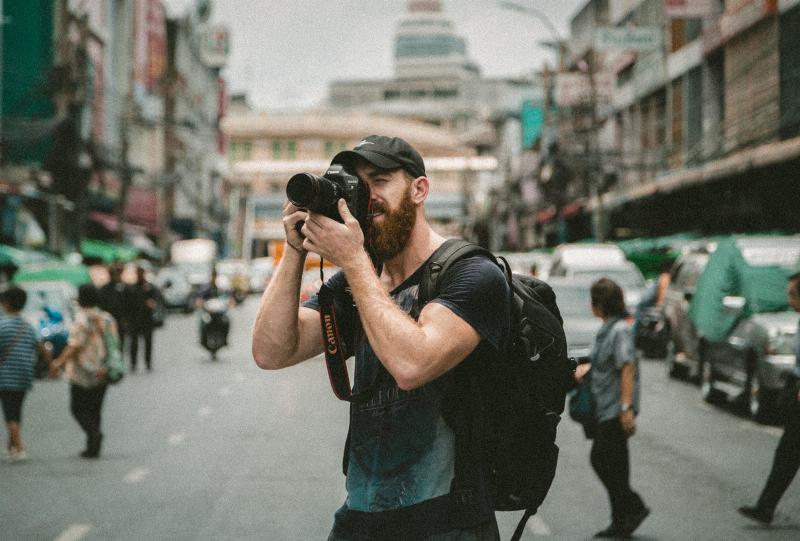 photographer man takes pictures in the street