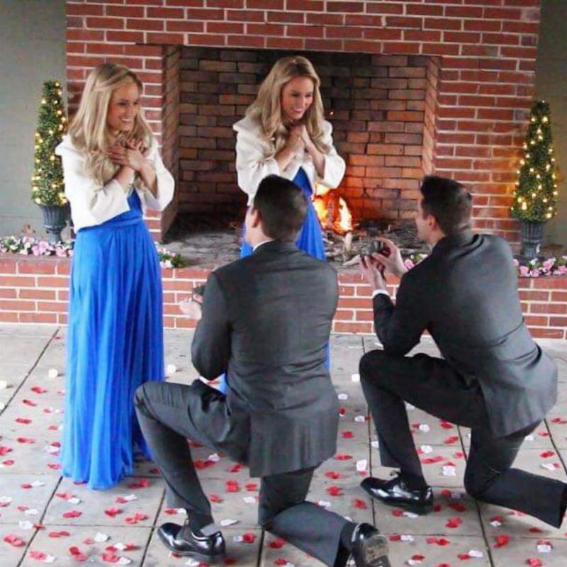 twin brothers on one knee proposing to twin sisters by petals