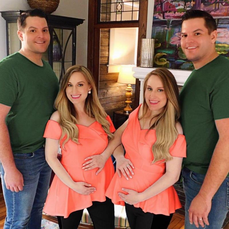 pregnant women in orange beside their twin husbands