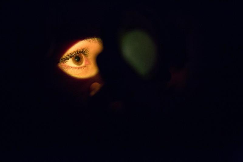 spotlight on brown eye in darkness