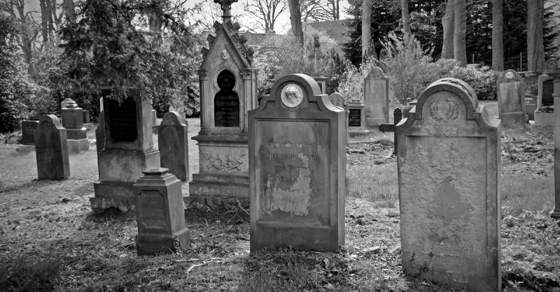 black and white tombstone in graveyyard