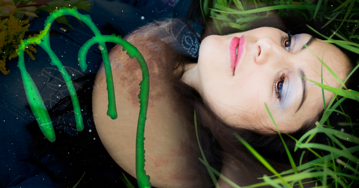 woman laying i grass with zodiac sign