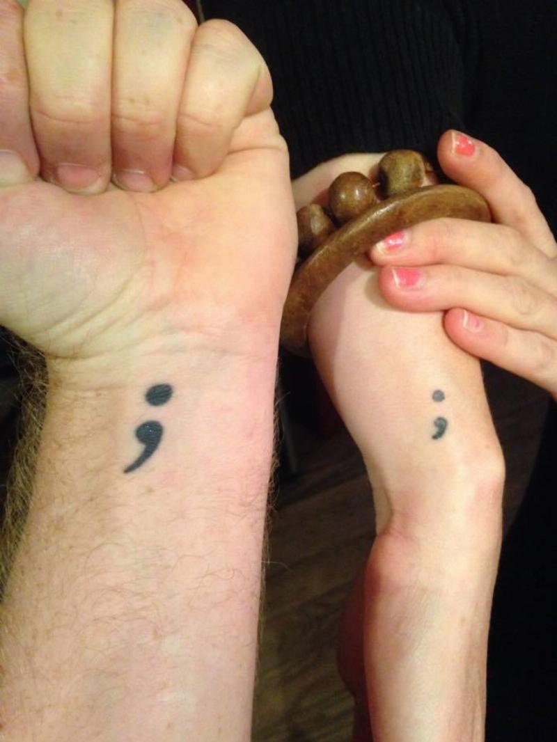 two arms showing off semi colon tattoos