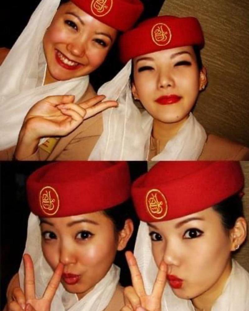 two flight attendants give peace sign