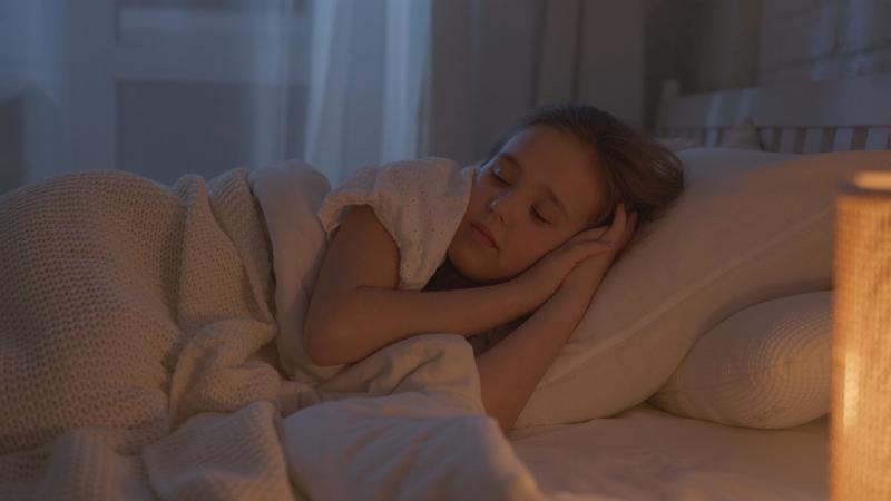 young girl sleeping in bed