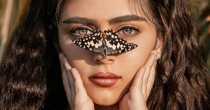 woman has butterfly on her nose