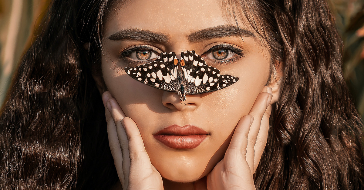 woman has butterfly on her nose