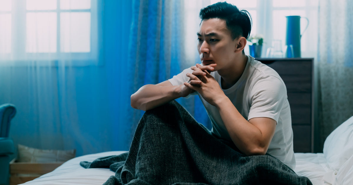 man sitting up in bed