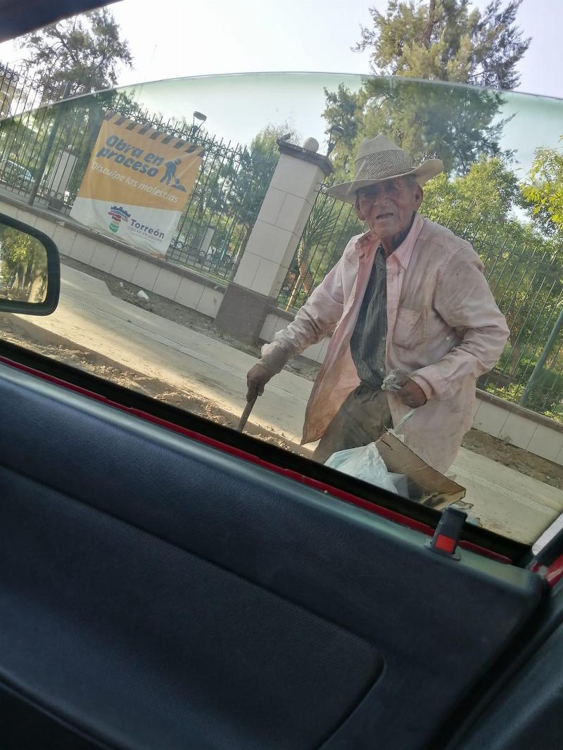 Don walks with cane by car window