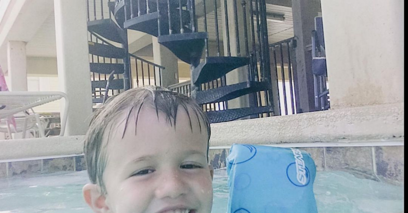 Levi swimming in the pool and looking athe camera