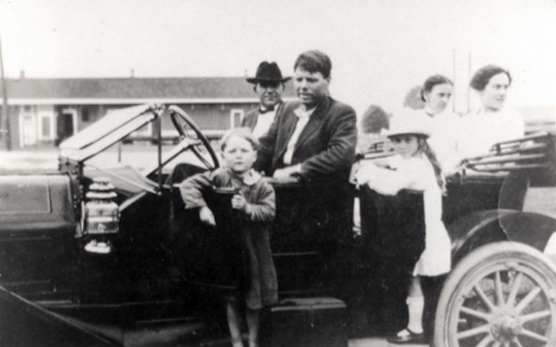 The child raised as Bobby Dunbar, now believed to be Bruce Anderson, standing in front of a car.
