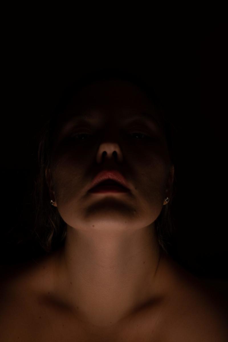 woman's face in shadow darkness