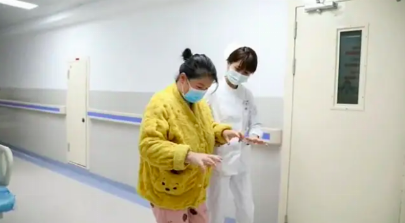 pregnant liu walking in corridor of hospital