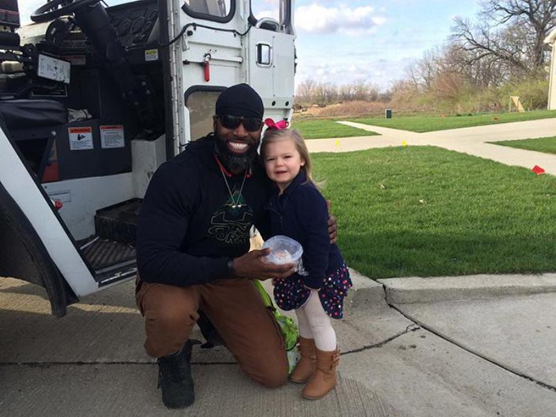 garbage man kneels to pose with cupcake and brooklyn