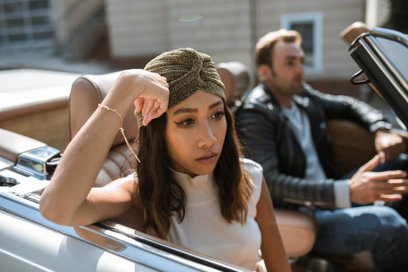 woman sitting in roofless car with man looking upset
