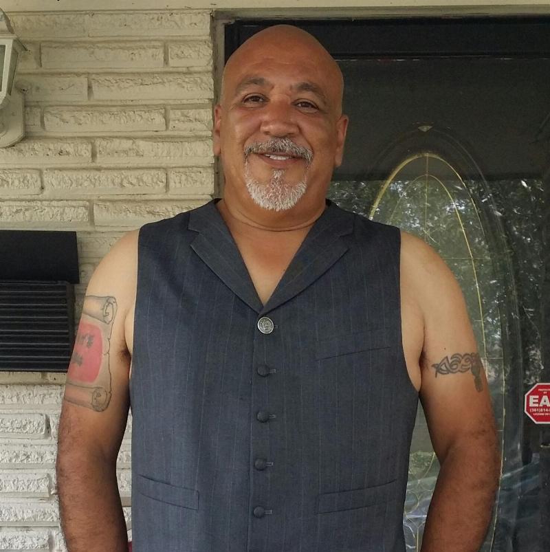 Ramirez profile picture posing in vest beside front door