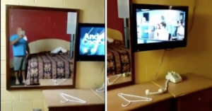 man in mirror of hotel on left and phone off hook on the right