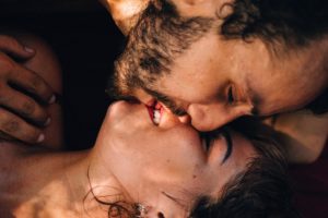 man leans down to kiss woman