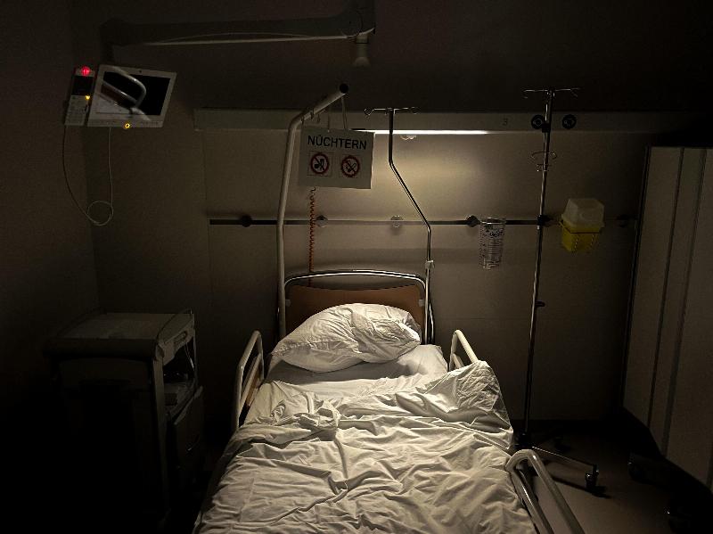 Dark room with empty hospital bed