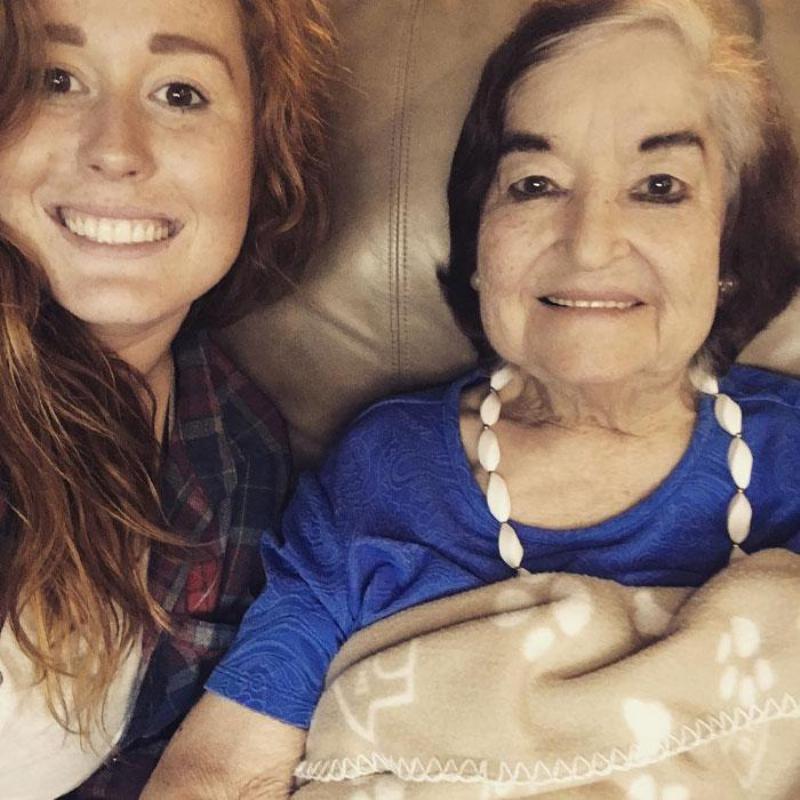 Elizabeth takes selfie with her grandma wrapped in a blanket