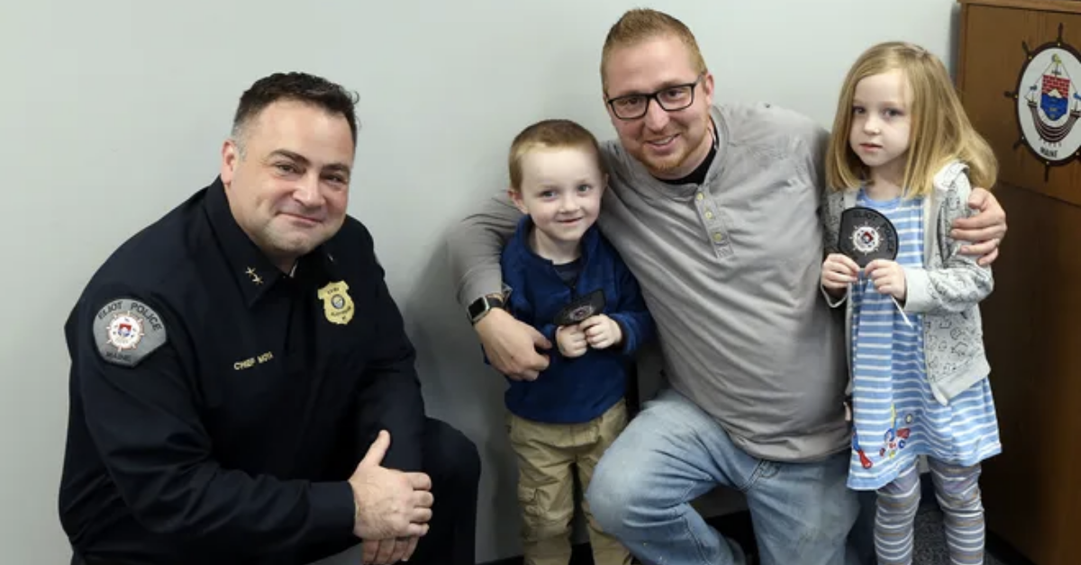 from left to right, police man givng thumbs up, 4 year old, dad and six year old