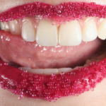 Tongue licking sugared red lips