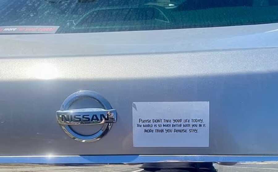 Motivational bumper sticker on nissan car